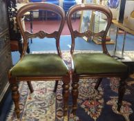 A set of four Victorian mahogany framed balloon back dining chairs.