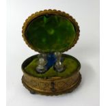 19th Century gilt metal box containing a group of five glass scent bottles, width 15cm, on bun