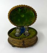 19th Century gilt metal box containing a group of five glass scent bottles, width 15cm, on bun