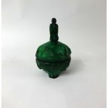 A green malachite coloured glass and decorated box and cover, surmounted with a figure,