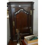 A Georgian oak wall hanging corner cabinet.