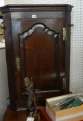 A Georgian oak wall hanging corner cabinet.