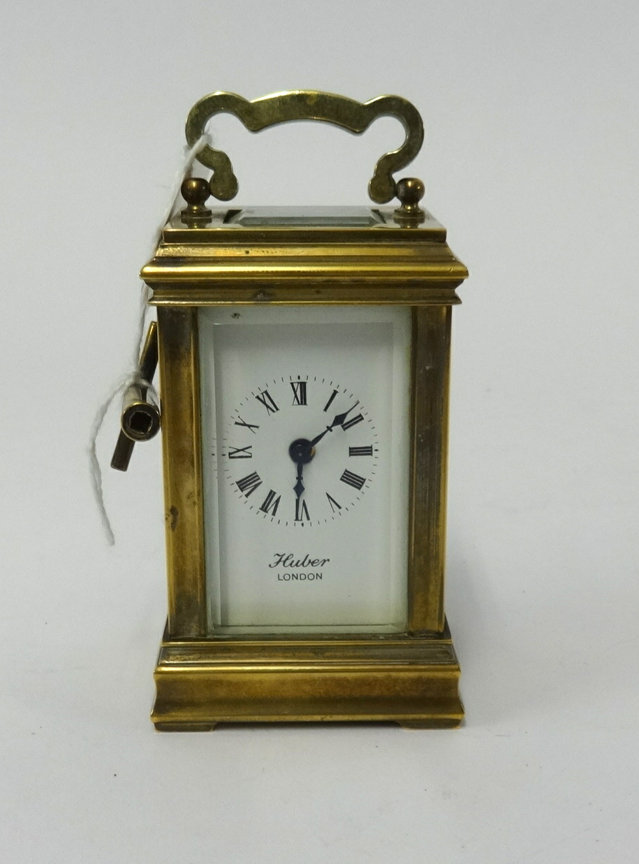 A miniature brass cased carriage clock, the dial marked, 'London' with platform escapement, height