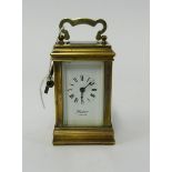 A miniature brass cased carriage clock, the dial marked, 'London' with platform escapement, height
