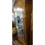 A mahogany single door wardrobe, with arched top and bevelled mirror plate, width approx 97cm.