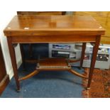 Edwardian mahogany and cross banded fold over games table.