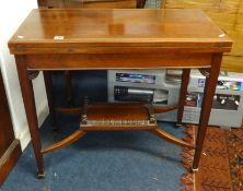 Edwardian mahogany and cross banded fold over games table.