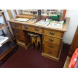 An oak pedestal desk fitted with nine drawers, width 123cm.