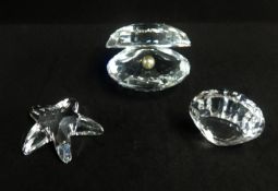 Swarovski, a collection consisting of Pear in shell, Star Fish, Sea Shell and Shark.