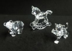 Swarovski, a collection of Bear with fish, Lion Cub, and Rocking Horse.