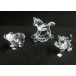 Swarovski, a collection of Bear with fish, Lion Cub, and Rocking Horse.