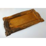 A Newlyn style copper rectangular tray, the border with embossed floral and pierced decoration, 41cm