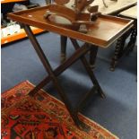 A Butlers tray on folding stand.