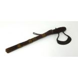 An old tribal axe with steel blade and leather and racked in shaft, length 51cm.