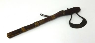 An old tribal axe with steel blade and leather and racked in shaft, length 51cm.
