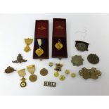 A collection of various military badges and buttons also cased medallions and a Victorian