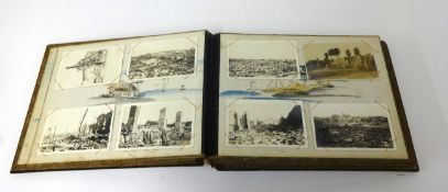 Two lacquered albums containing various postcards including Tokyo, Shanghai, 1920's Singapore,