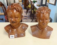 A pair of carved wood busts, girl and boy, height 23cm.