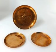 A pair Newlyn copper circular coasters, stamped in the centre, diameter 9.5cm also a larger