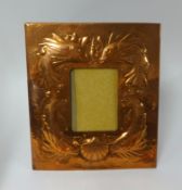 A Newlyn copper picture frame embossed with fish and a shell, impressed 'Newlyn' to verso, 30cm x