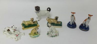 A porcelain pug model, pair of porcelain pug groups on cushions, pair of greyhounds and other animal