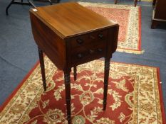 A Victorian mahogany work table fitted with two real and two dummy drawers on ring turned legs,