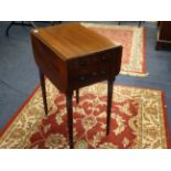 A Victorian mahogany work table fitted with two real and two dummy drawers on ring turned legs,