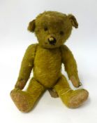 An early 20th Century German teddy bear with hump back and glass eyes, height 47cm circa 1920/30.