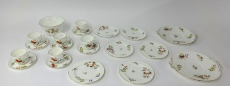 A late 19th/early 20th century porcelain six setting tea set, decorated in bright flowers and