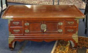 A 20th Century Chinese hardwood low table, fitted with an arrangement of drawers and cupboards