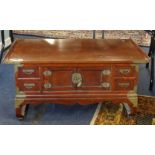 A 20th Century Chinese hardwood low table, fitted with an arrangement of drawers and cupboards