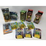 Various collectors action figures including Tron Legacy, Osbourne caricatures and Pokémon packs.