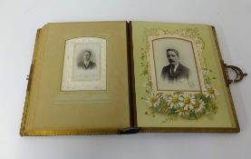 An Edwardian photograph album inscribed 'Christmas 1900' with some family portraits.