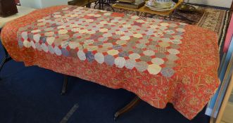 A patchwork quilt together with various Royal napkins and tablecloth.