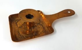 A Newlyn copper chamber stick with embossed fish design, stamped on the front and reverse, length