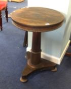 A 19th Century rosewood pedestal wine table on platform base together with a mahogany tripod