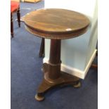 A 19th Century rosewood pedestal wine table on platform base together with a mahogany tripod