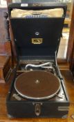 HMV, a wind up table top gramophone with various '78 records.