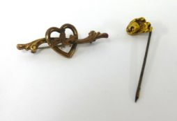 A gold nugget tie pin and a 9ct gold heart brooch.