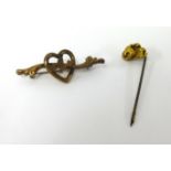 A gold nugget tie pin and a 9ct gold heart brooch.