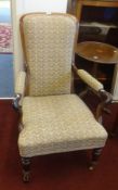 A Victorian mahogany framed elbow chair on castors.