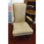 A Victorian mahogany framed elbow chair on castors.