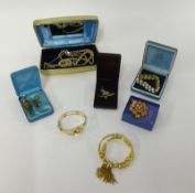 A quantity of various dress jewellery, gilt bangles, brooches, pendants etc.