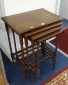 A nest of four mahogany tables with ring turned legs.