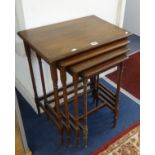 A nest of four mahogany tables with ring turned legs.