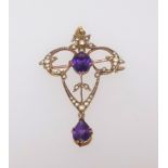 A 9ct antique pendant brooch set with amethyst and seed pearl.