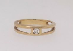 A diamond single stone ring, finger size N, set in unmarked yellow gold.
