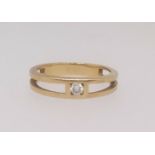 A diamond single stone ring, finger size N, set in unmarked yellow gold.