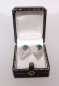 A fine pair of 18ct emerald and diamond earrings.