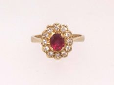 An 18ct ruby cluster ring stamped 'EJ Co', finger size L.